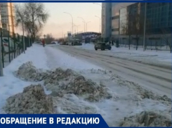 Возле спорткомплекса снег вывезли с проезжей части на тротуар в Волгограде: видео 